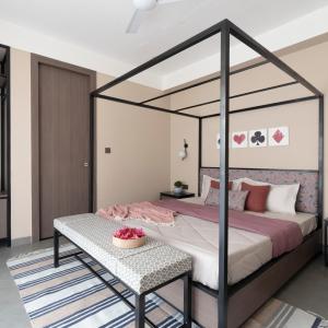 een slaapkamer met een hemelbed en een tafel bij The Deck in Jaipur