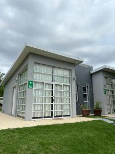 a large gray building with large windows at Complejo Las Palmeras in Colonia del Sacramento