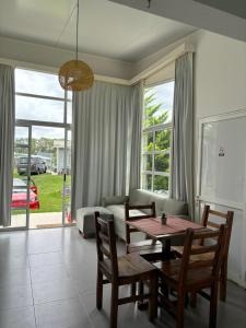 a living room with a table and chairs and a couch at Complejo Las Palmeras in Colonia del Sacramento