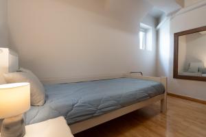 A bed or beds in a room at Bright, Cosy Studio close to Glyfada Beach & Center