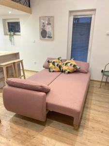 a large pink ottoman sitting in a living room at Apartma Tany in Ljubljana