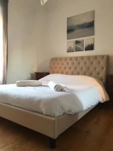 a bedroom with a bed with a white bedspread at Appartamento 5 stelle in Piazza Asti - Re di Roma - in Rome