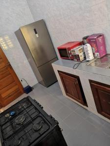 a kitchen with a stove and a counter top at YAYA in Cotonou