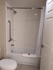 a bathroom with a white tub and a toilet at ReVi Columbus North in Columbus