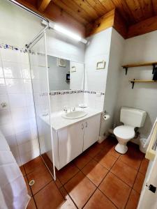 a bathroom with a white sink and a toilet at Just Beachy Loft Villa in Mandurah