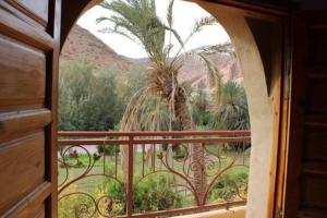 a view of a palm tree from a balcony at Gite TALBOURINE in Taroudant