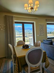 a dining room with a table and chairs with a view at Kallisto villas in Kalívia