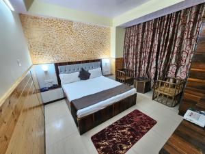 a bedroom with a bed and a large window at Hotel Taj Palace near Mall Road in Shimla