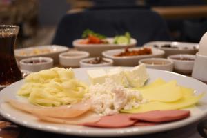 a plate with cheese and other foods on a table at Cibali Hotel Istanbul in Istanbul +36 photos