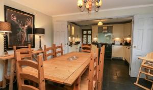 a dining room with a wooden table and chairs at Scandale Cottage in Ambleside +21 photos