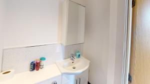 a white bathroom with a sink and a mirror at Flat 302 Centre Nottingham in Nottingham