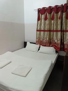 2 camas en una habitación con cortina en The Royal Lake View Villa, en Udaipur