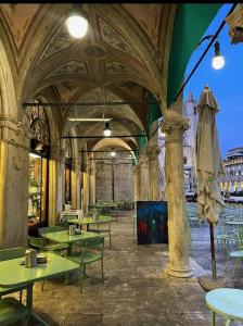 a restaurant with tables and chairs in a building at Lilli's Home in Ascoli Piceno