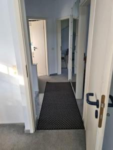 a hallway with a black mat in a room at Gemütliches Gästehaus in ruhiger Waldlage in Büdingen