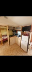 a small kitchen with a bunk bed in a room at Mobilhome 6 personnes in Angles