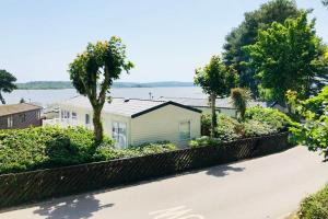 a house on the side of a road at Family Seaside Retreat Private Stay at 5-Star Rockley Holiday Park Poole in Poole +46 photos