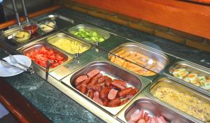 a buffet line with trays of different types of food at Penzion Larion in Kráľová Lehota +65 photos