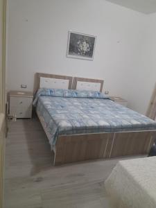 a bedroom with a large bed in a room at VILA MOZAIK in Kavajë