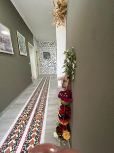 a hallway with flowers on the floor of a building at VILA MOZAIK in Kavajë