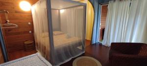 a bedroom with a bed in a glass room at HOME CONTAINER RESORT Terre in Sainte-Rose