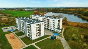 an aerial view of a building next to a river at Retro Apartment Iława in Iława