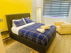a bedroom with a bed with two pillows and a window at Royal Blue Grand Suite No 1 in Piraeus