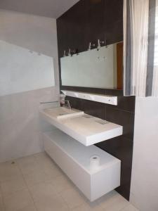 a white bathroom with two sinks and a mirror at Allotjament amb encant a Tremp in Tremp