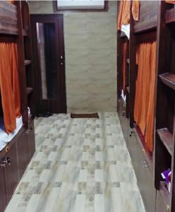 a room with a tiled floor and a door at Kalina Asian Dormitory in Mumbai