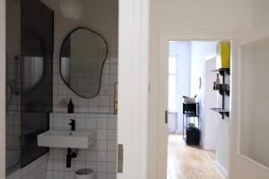 a bathroom with a sink and a mirror at Design Apartments Weimar Altstadt in Weimar