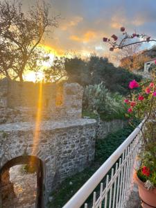 a rainbow over a stone bridge with flowers at Sideroporta castle Náfpaktos in Nafpaktos