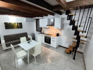 a kitchen and living room with a table and chairs at Casa Chiara in Apricale +1 photo