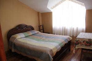 sypialnia z łóżkiem i oknem w obiekcie Lago Sagrado Titicaca - Casa de Campo & Agroturismo 
