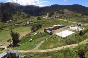 an aerial view of a farm in a field at Lago Sagrado Titicaca - Casa de Campo & Agroturismo in Huayllara +10 photos