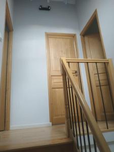 a staircase with two wooden doors in a room at la grange Saint Georges in Hermaville +18 photos
