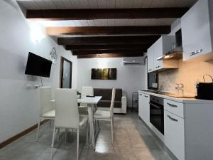 a kitchen and dining room with a table and chairs at Casa Chiara in Apricale