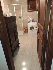 a bathroom with a sink and a washing machine at Frontemare in Porto Santo Stefano