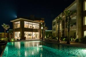 a swimming pool in front of a building at night at Dakhla South Bay in Dakhla