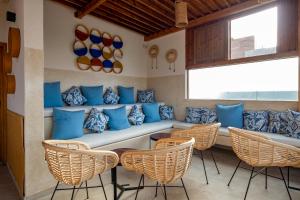 a seating area in a resort with blue pillows and chairs at Dakhla South Bay in Dakhla
