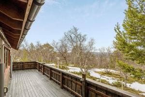 a porch of a house with a snow covered yard at Koslig hytte ved Grimsdalen in Dovre +18 photos