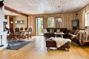 a living room with a couch and a table at Koslig hytte ved Grimsdalen in Dovre