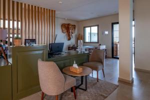 a lobby with chairs and a counter with a table at Dakhla South Bay in Dakhla