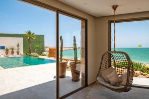 a porch with a swing and a view of the ocean at Dakhla South Bay in Dakhla