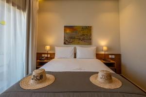 a bedroom with a bed with two hats on it at Dakhla South Bay in Dakhla