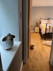 a room with a room with a bed and a stuffed animal on a counter at Shepherd's Cottage in Totland +1 photo