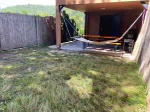 a hammock in the backyard of a house at SKH R, 1 apartment, 2 bedrooms in Praid