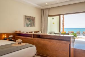 a bedroom with a bed and a view of the ocean at Dakhla South Bay in Dakhla