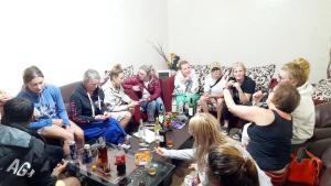 a group of people sitting on a couch at Bel View Guest House in Haputale