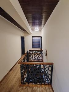 a hallway with white walls and a wood ceiling at ALEXANDER Ski Lake View in Beliş