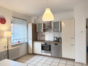 a kitchen with white appliances and a window at Möbliert-Ruhige Lage- W-LAN -Netflix-Herne in Herne