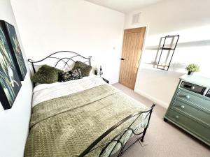a bedroom with a bed and a green dresser at 6 Guests - 3 Bed House in Chester-le-Street in Chester-le-Street